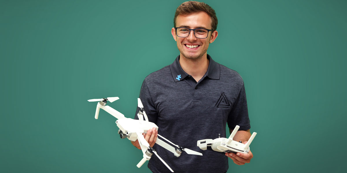Nick Kiraly holding a drone and remote.