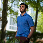 Rajan Thummar on campus with his hands in his pockets.