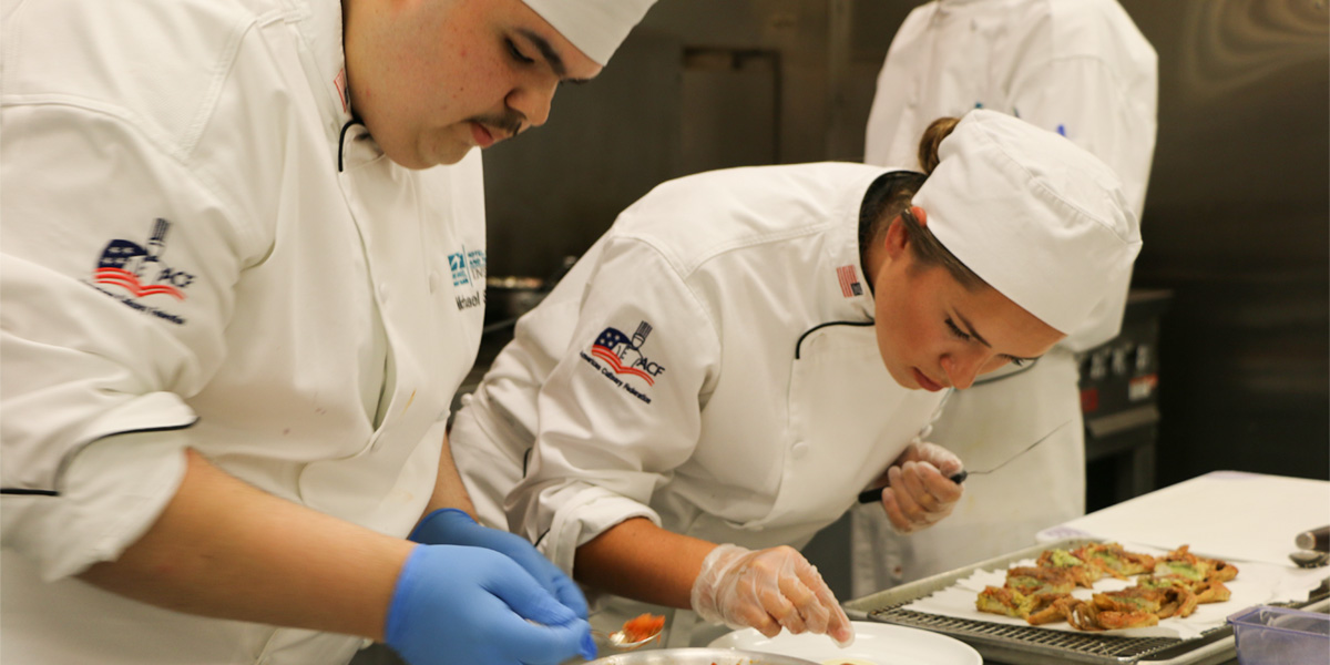 Two HCAT students work on their dishes for the Atlantic Cup.