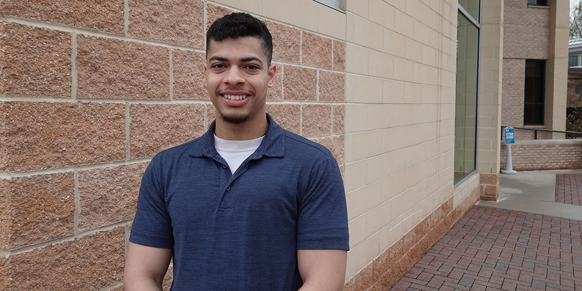 Student Judah Contreras standing in front of Ludlum Hall