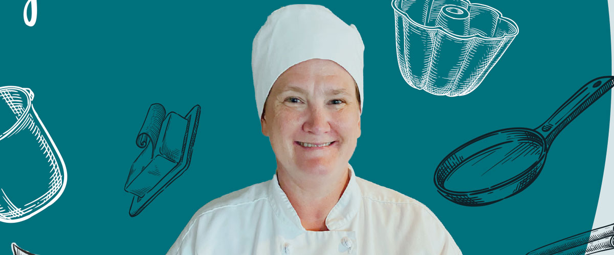 Image of Nicole Luecke in a baker's uniform with baking graphics.