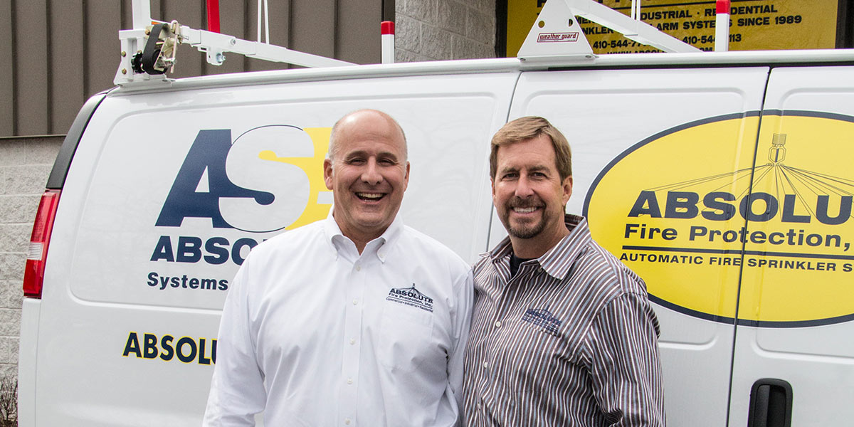 Larry Cate and Dan Mathias in front of Absolute Fire Protection van.