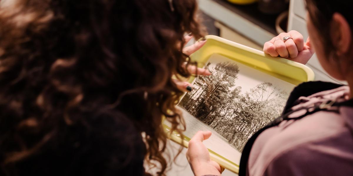 Photography students looking at print photo.