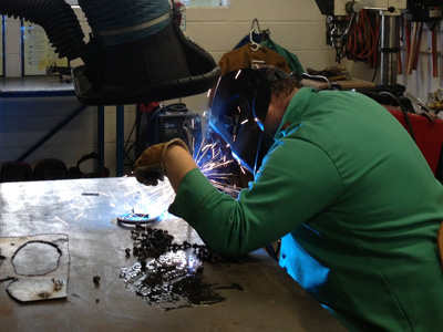 AACC student works with metal.