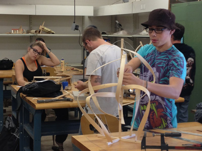 AACC art students work with wood.
