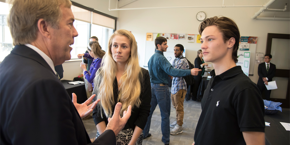 business students in a discussion at business law event