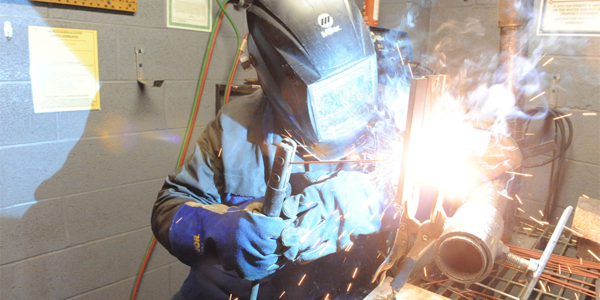 AACC welding student with torch