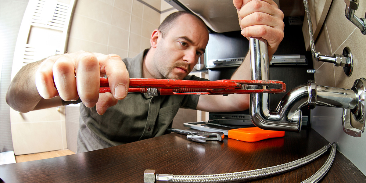 Plumbing apprentice works on pipes. 