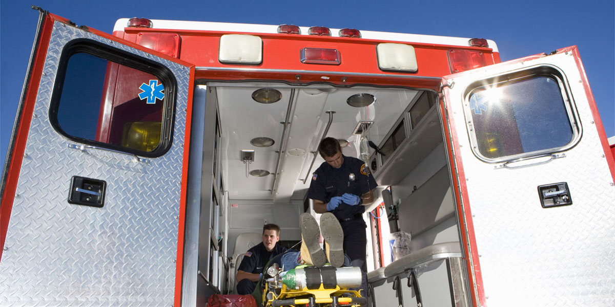 Emergency medical technicians in the back of an ambulance
