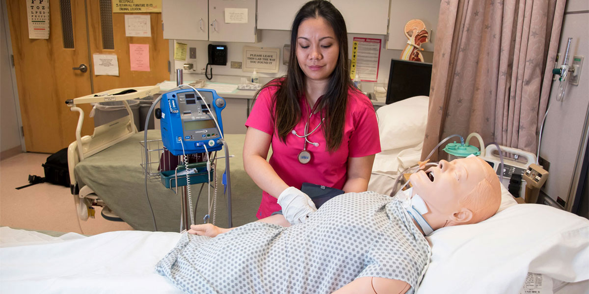 AACC student works with patient simulator. 