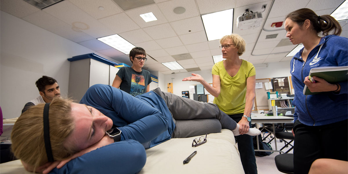 AACC physical therapy students learn from instructor in classroom.