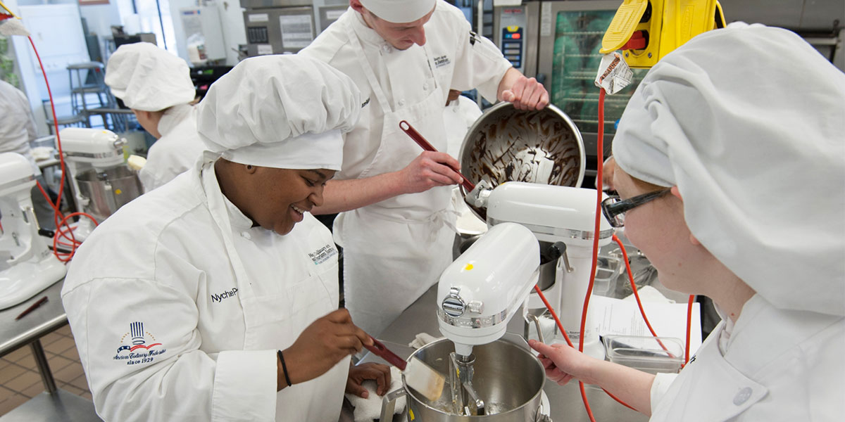 Culinary students work in commercial kitchen
