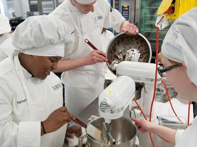Culinary students work in commercial kitchen