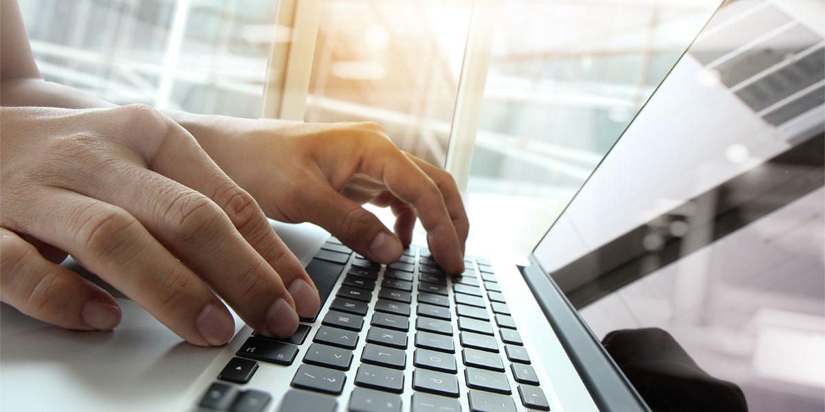 person typing on computer keyboard