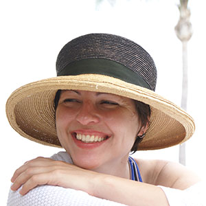 Grace Sikorski wearing a hat and smiling while looking over her shoulder