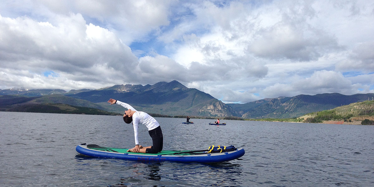 Loraine Frey stretching on a paddleboard
