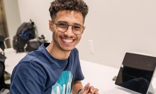 Student smiling with tablet