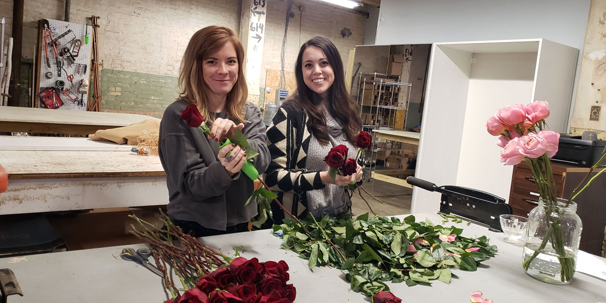 Student Sar Gray-Foreman and mentor Carly Thurman with flowers.