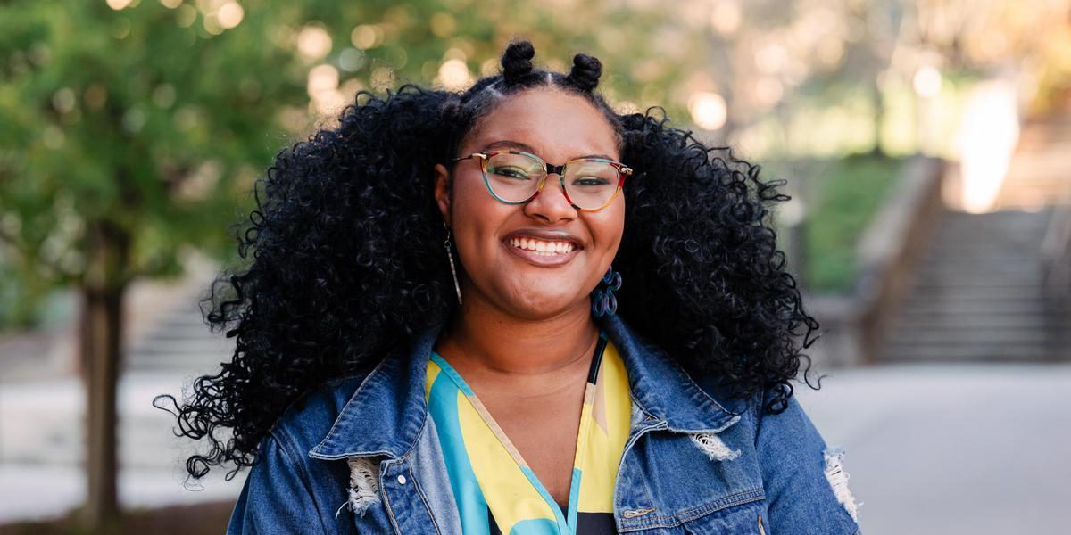 Essence outside and smiling.
