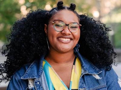 Essence outside and smiling.