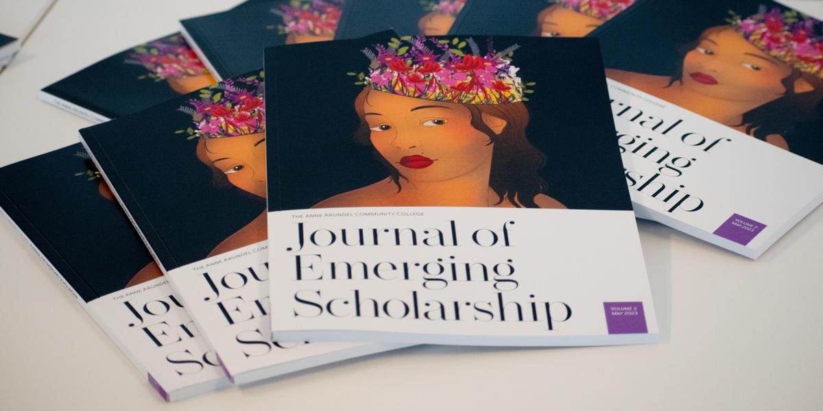A pile of journals fanned out across a table. The cover features a woman with a floral headpiece.