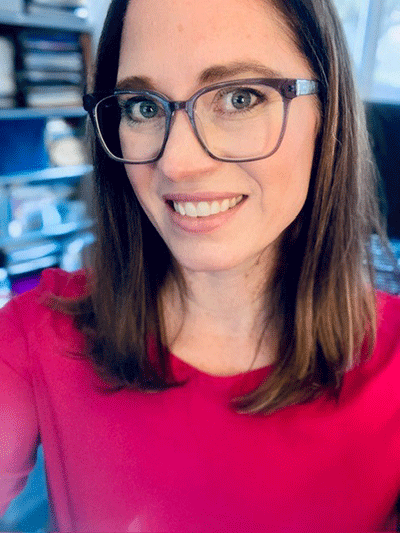 Headshot of Megan Myers wearing a pink sweater