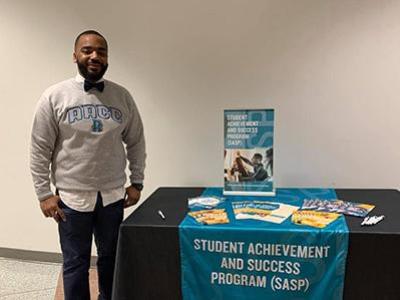 Reggie Stroble stands next to a table promoting SASP.