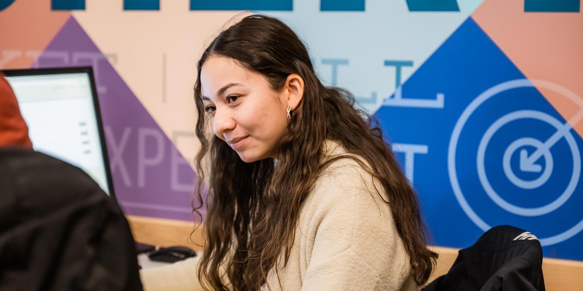 Jazmin volunteering with a client at VITA tax prep.