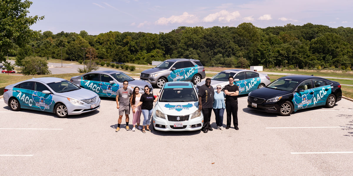 Group shot of the Road Hawks with their cars.