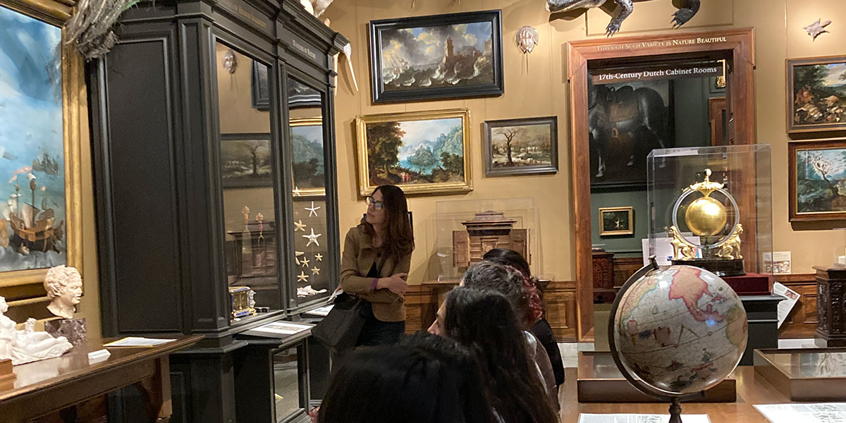 Students explore the curiosity cabinet at the Walters Art Museum