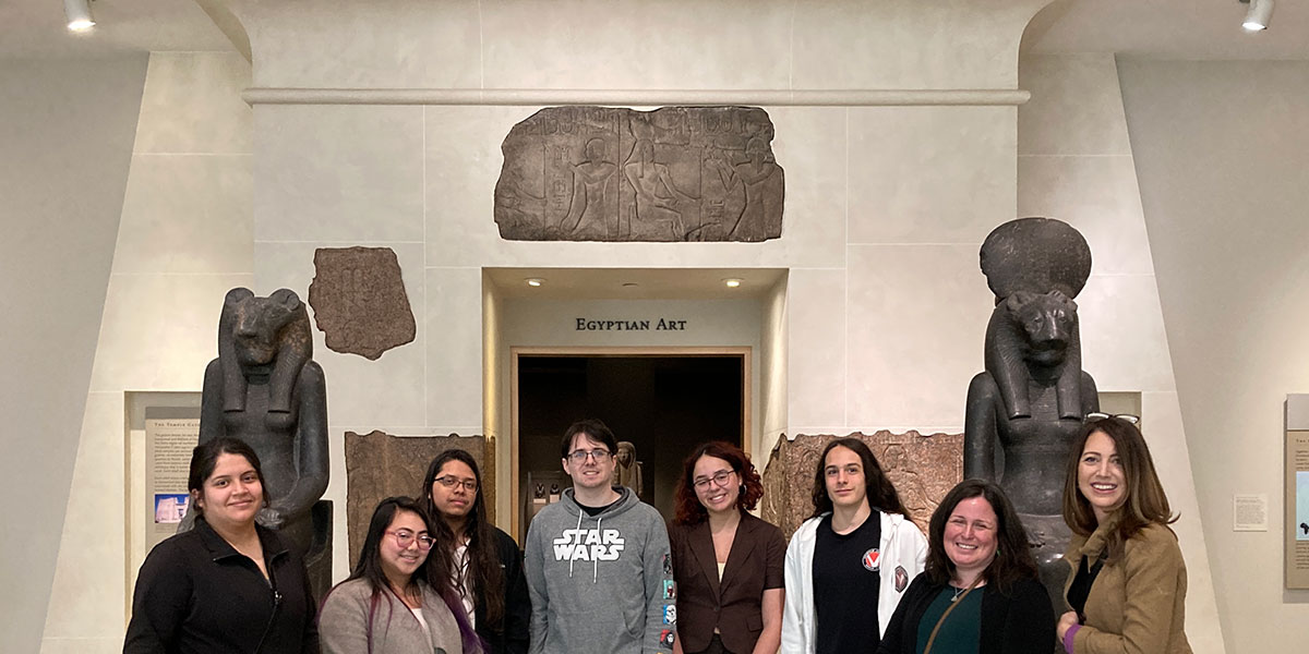 Students pose together with Visual Arts Program Navigator Laura Pasquini and Assistant Professor of Anthropology Amy Carattini at the Walters Art Museum