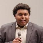 Chris Chambers speaks in front of a group at orientation.