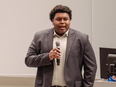 Chris Chambers speaks in front of a group at orientation,