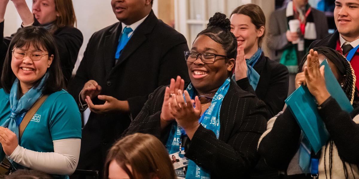 Nakiera clapping in a crowd at Student Advocacy Day