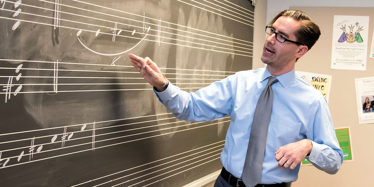 Ian Wardenski, associate professor for music, at the blackboard.