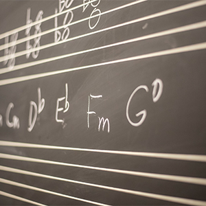 Music notation on a chalk board.