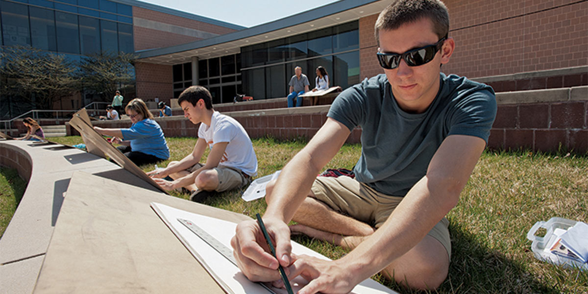AACC art student draws outdoors.