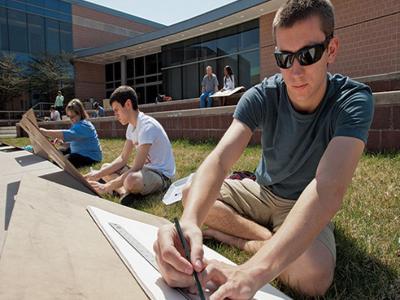 AACC Art student draws outside.