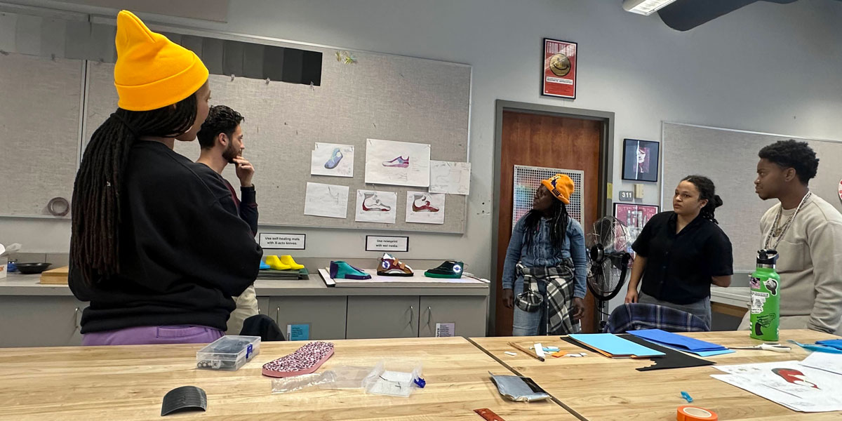 Students looking at art project.