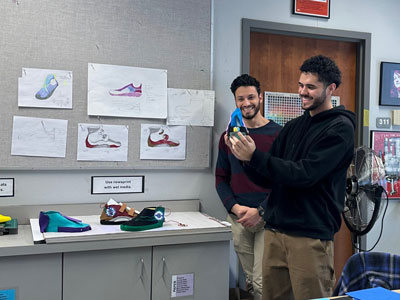 Students looking at art project.