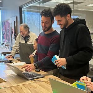 Students looking at laptop in class
