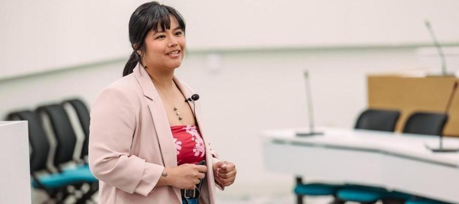 A student speaks during a business pitch competition.