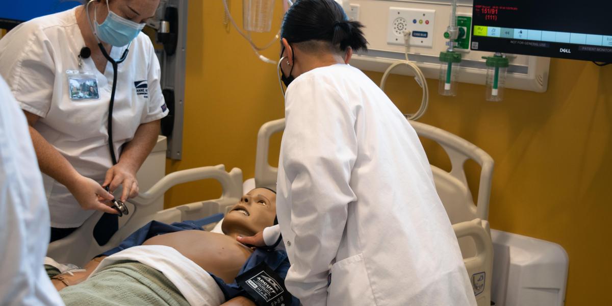 Nursing students in lab instruction.