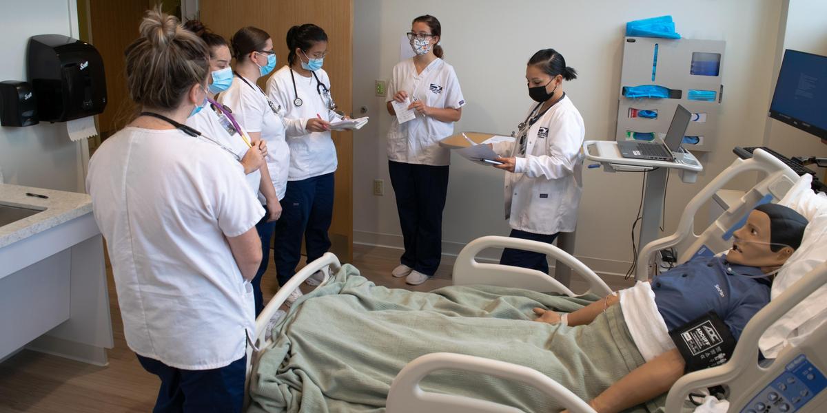 Nursing students in lab instruction.