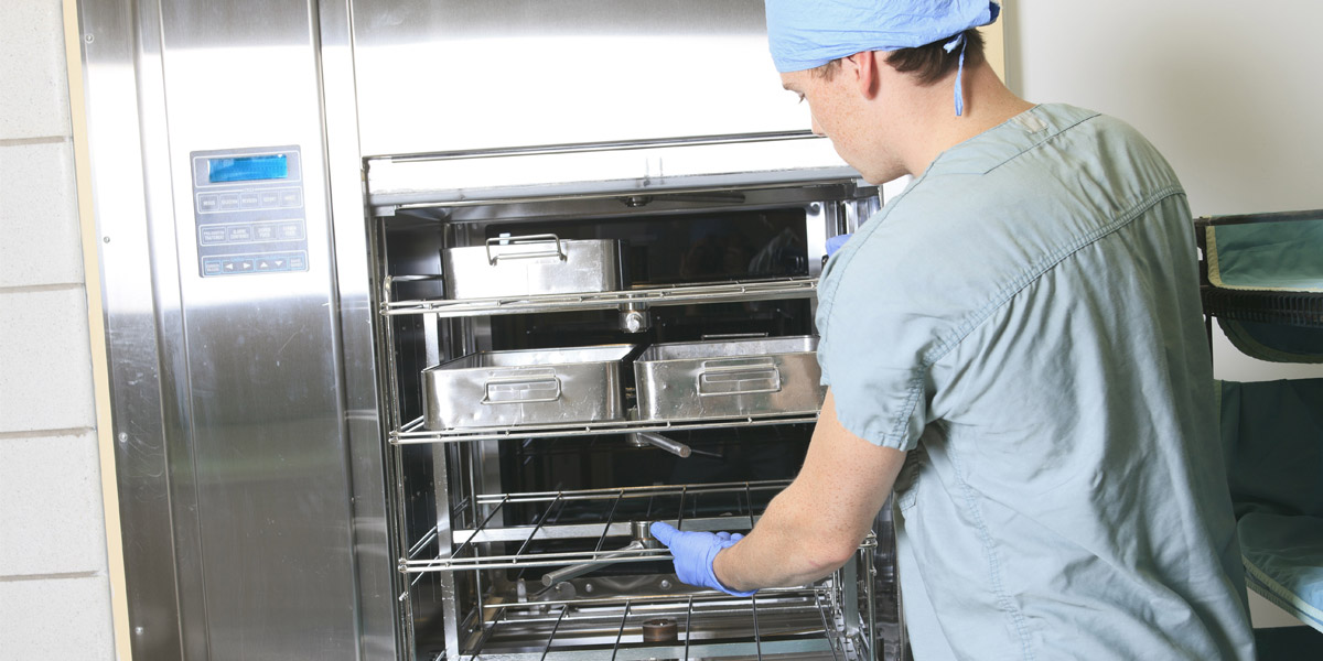 A health care professional removes sterile supplies from cart.