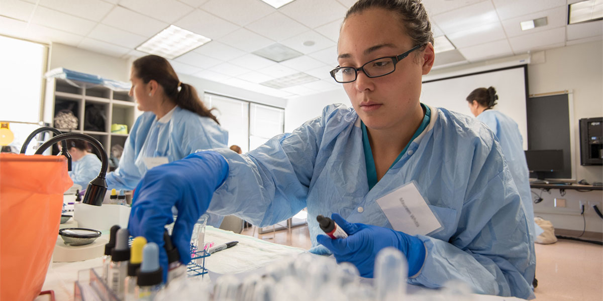 AACC student phlebotomy tech works in the lab.