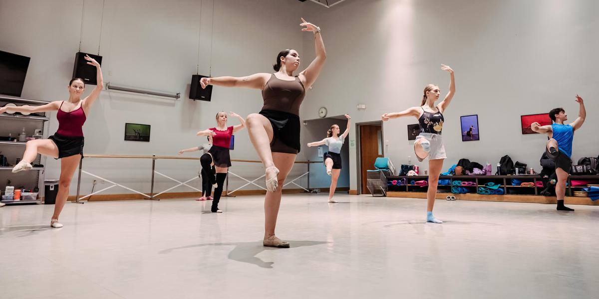 Students strike a pose in a ballet class.