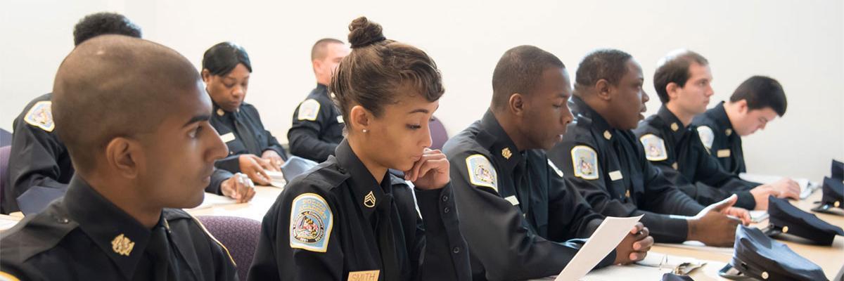 Row of police academy cadets in a classroom