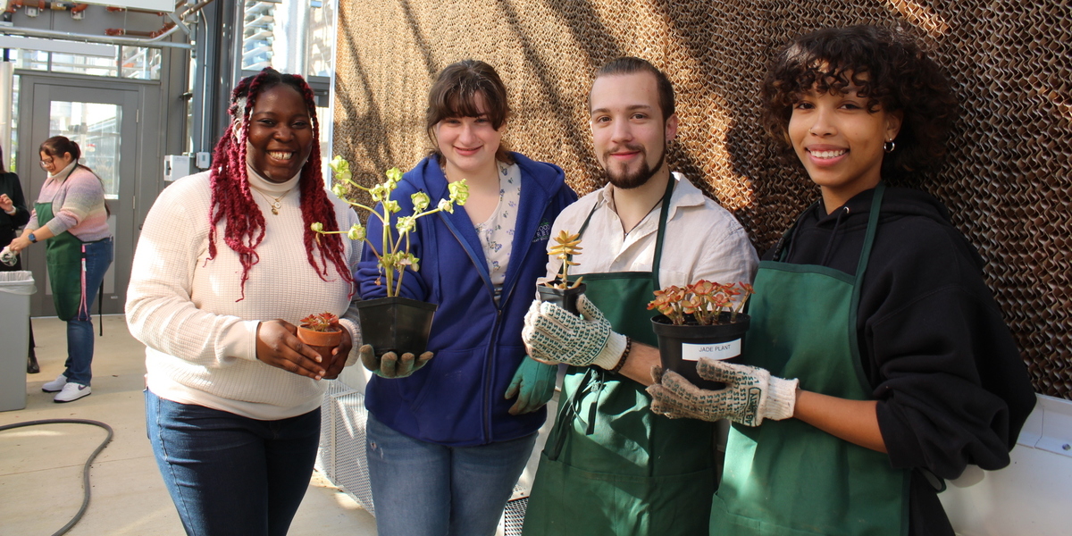 Students posing with plants.
