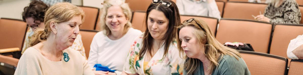 A group of faculty and staff sitting together in a classroom.
